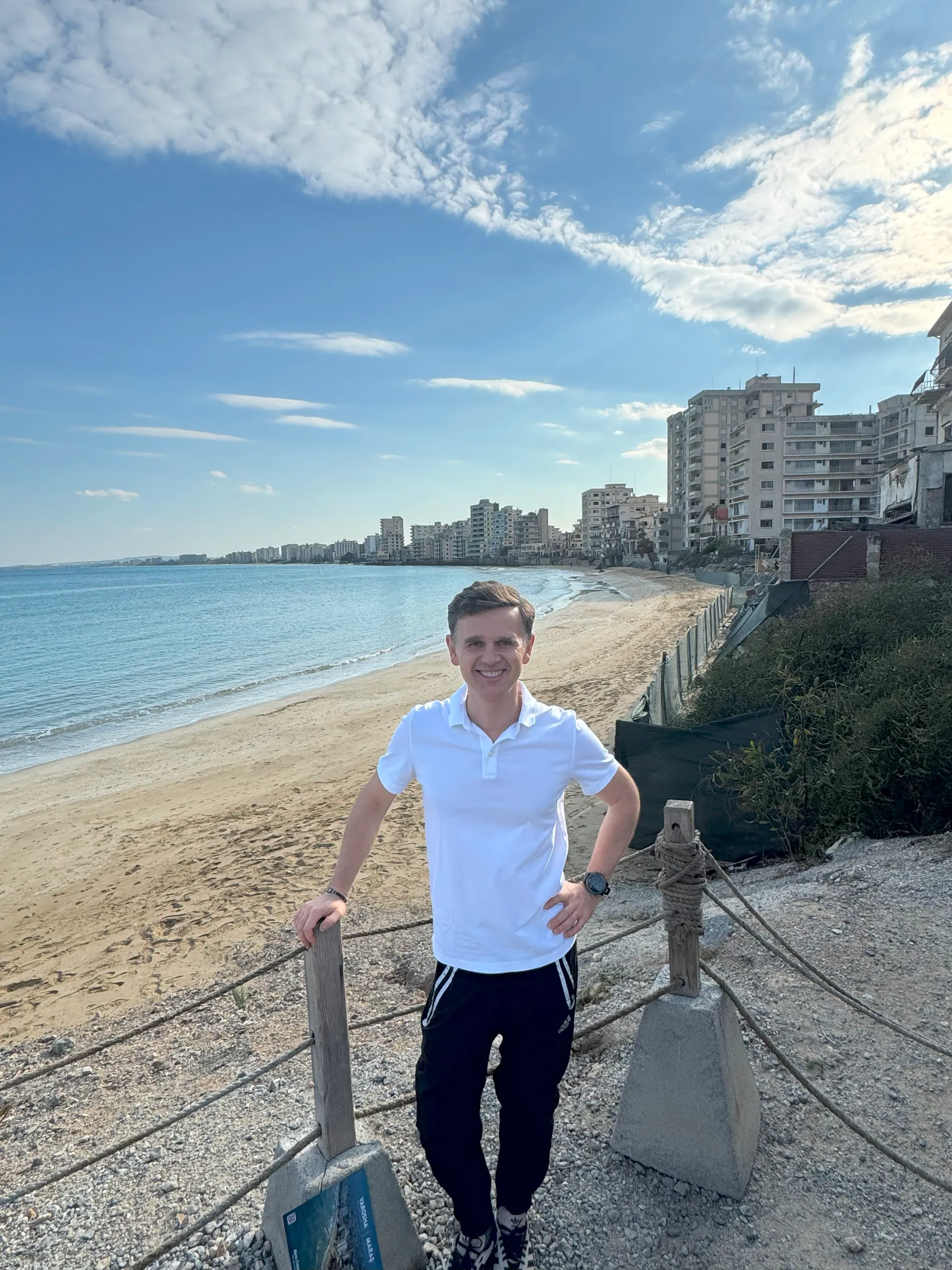 Standing at the edge of Varosha’s iconic Golden Sands, with the silent, abandoned high-rises of Famagusta stretching into the distance - a reminder of a once-thriving resort now frozen in time.